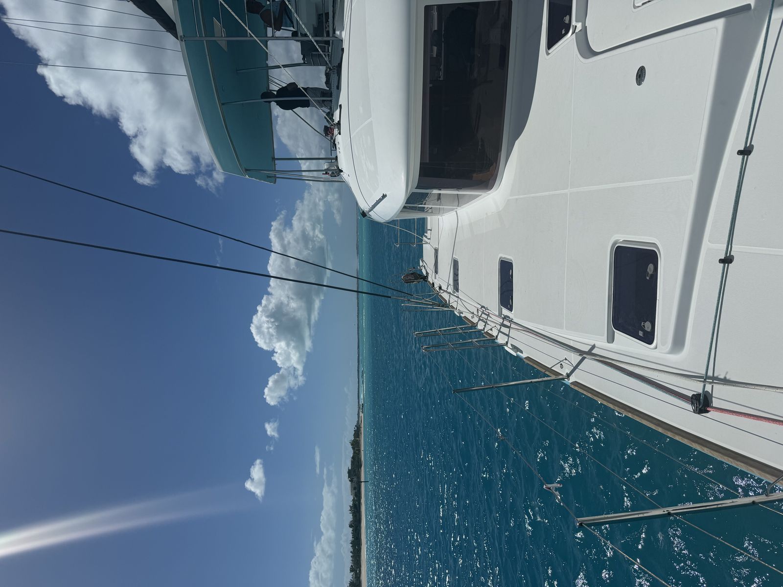 Pretty Lucky — white hull and flybridge on turquoise coastal water