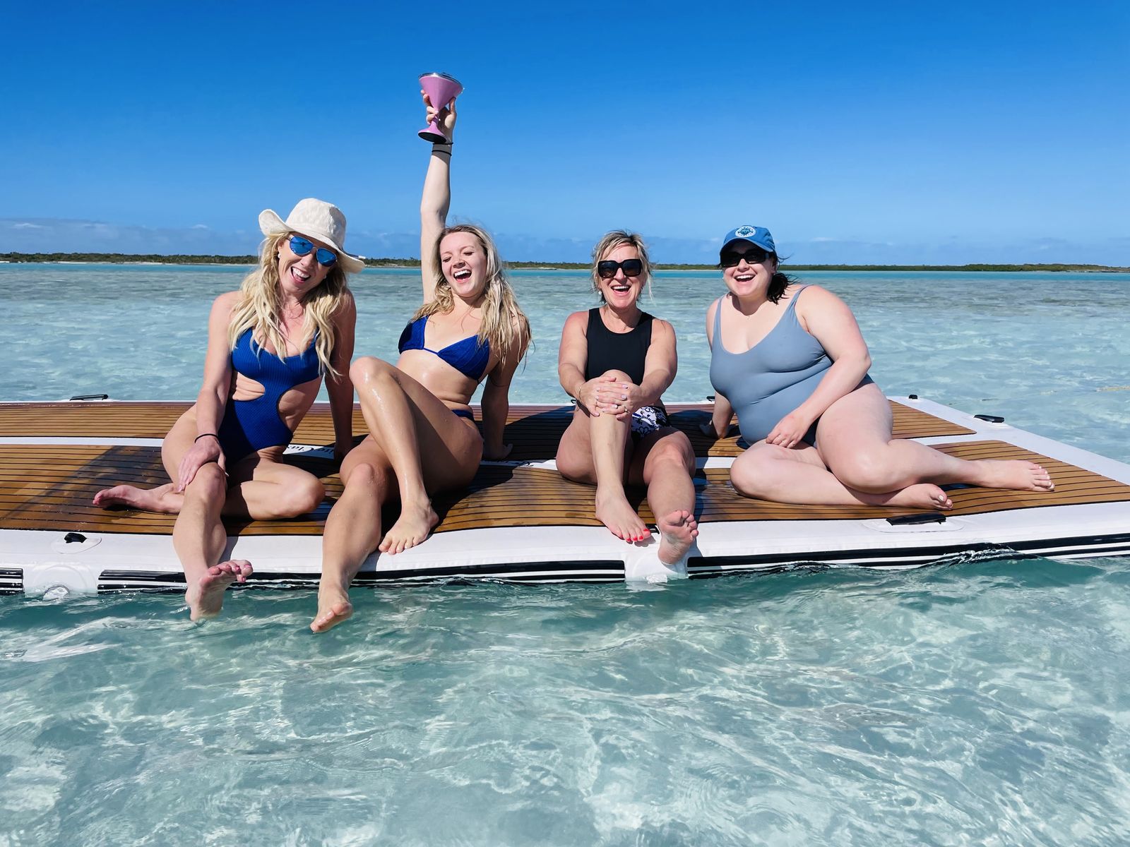 Friends laughing on a floating wooden deck