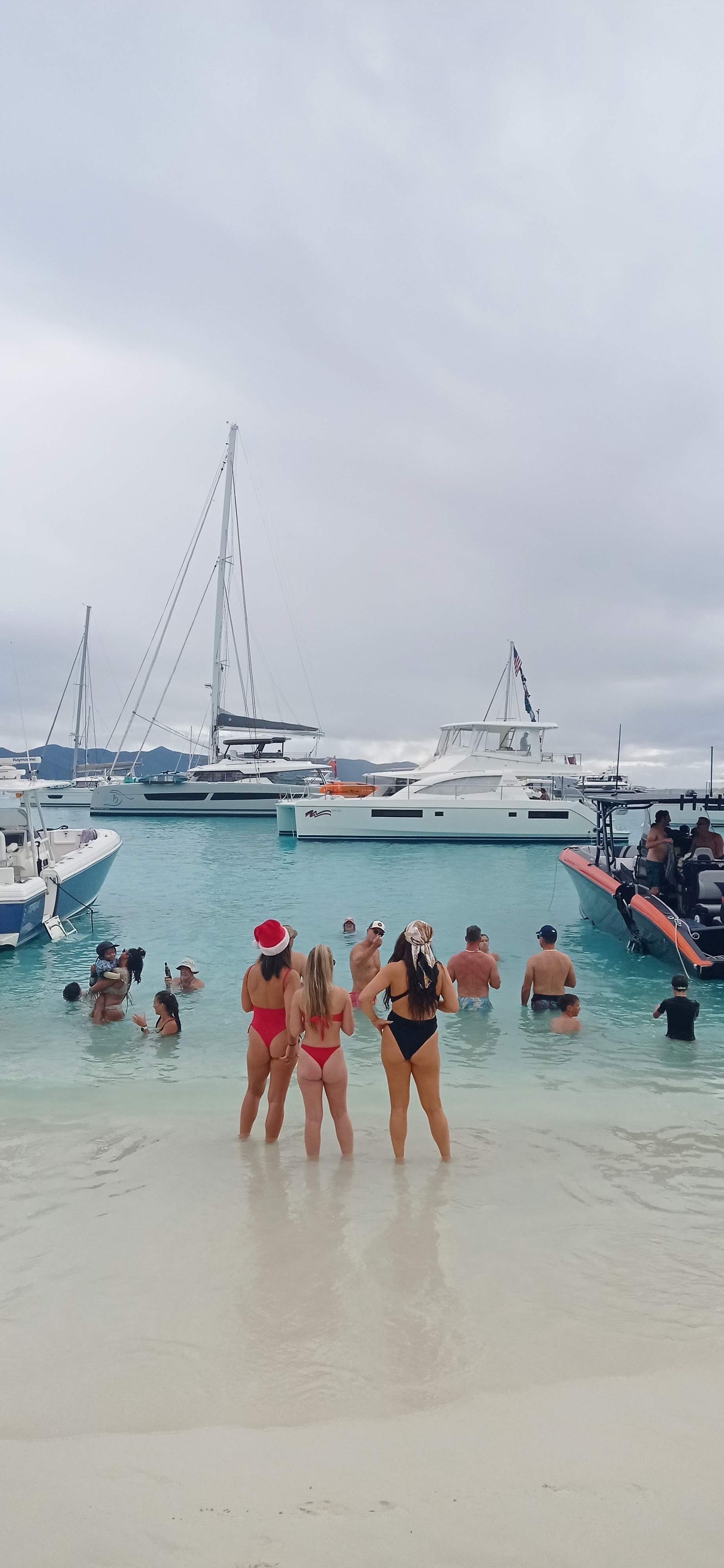 Friends wading in clear turquoise shallows