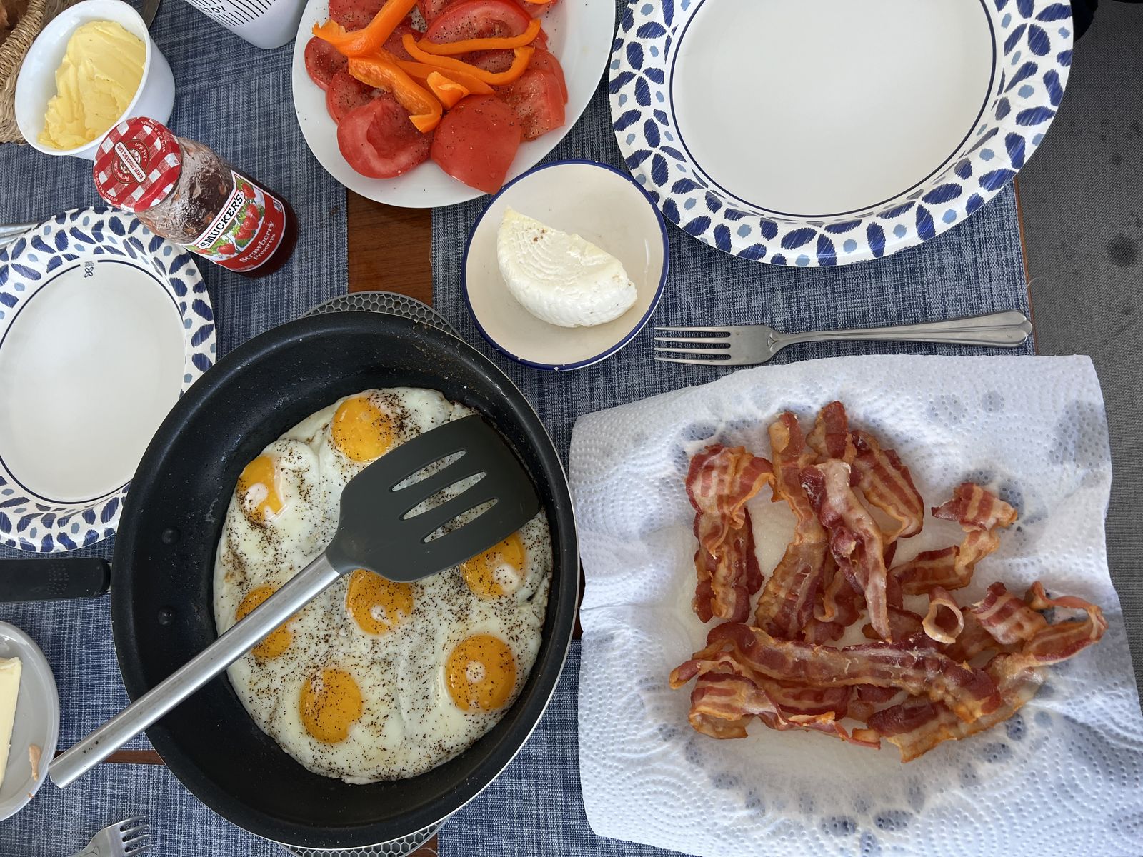 Aboard breakfast — eggs, bacon, and fresh fruit on the table